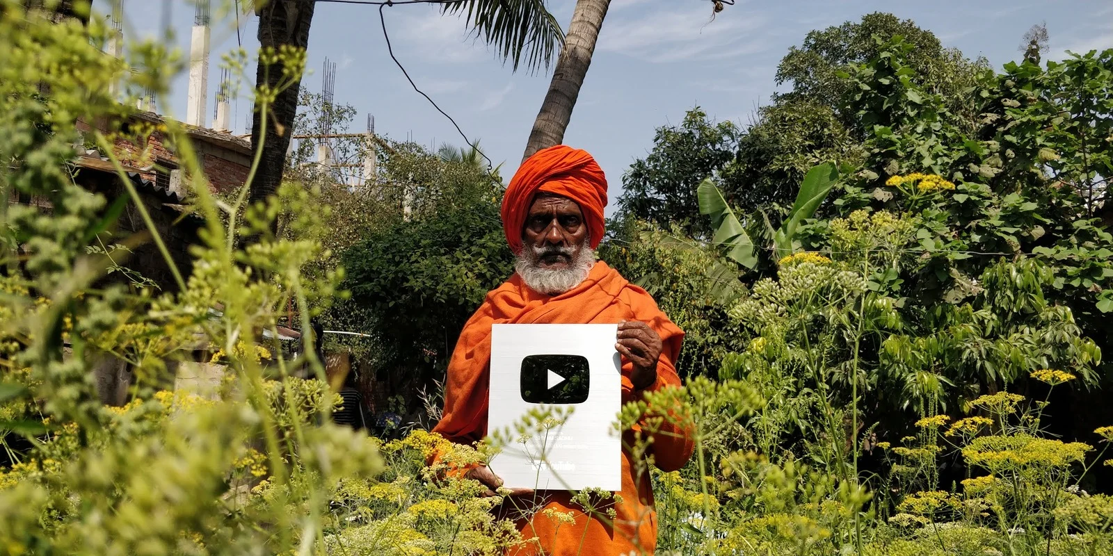 Temporary stand-in (real photo, reused) — Shyam Sadhu outdoors among garden greenery. Not the final Environmental Work image; replace via CMS.
